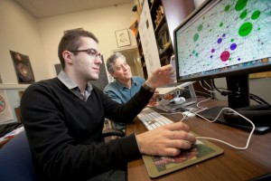Dorde Rakic ’15 and Professor Gary Gordon look over a matrix of information.