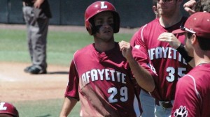 Andrew Santomauro '14 is congratulated by his baseball teammates after scoring a run.