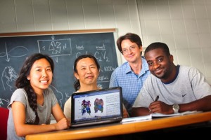 Tiffany Phuong ’16; Chun Wai Liew, associate professor of computer science; Robert Kurt, associate professor and head of biology; and Kofi Boateng ’16 review their work in a lab in Kunkel Hall.
