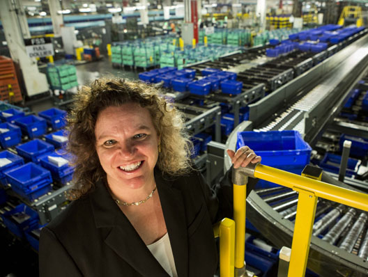 Karen A. Pompanella '88 observes new flat sequencing system, Brentwood Post Office Facility, Washington, D.C. Photo by Jeffrey MacMillan.