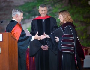 Edward Ahart ’69, left, chair of the Board of Trustees, and Stephen Pryor ’71, vice chair of the board, congratulate President Alison Byerly.