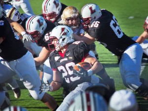 Tailback Ross Scheuerman '15 carries the ball during last year's game.