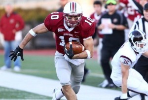 Mark Ross '14 runs with the football during a game.