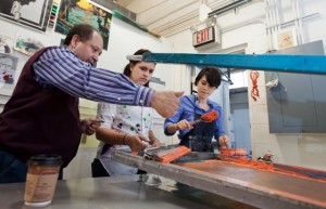 Professor Curlee Holton works with students at the Experimental Printmaking Institute.
