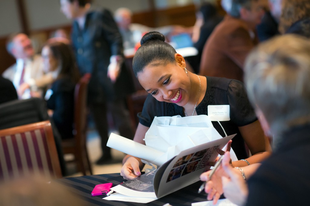 Jiselle Peralta, '13, of the Alumni Council, browses through Live Connected/Lead Change campaign brochure.