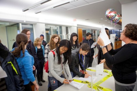 Katherine Furlong, right, associate director for access and administrative services, welcomes students to the hunt.