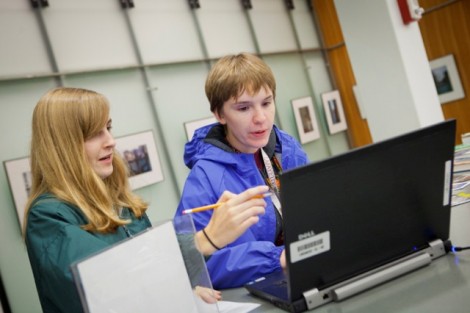 Kaitlin Brown '15 and Haley Garrison '15 find a clue at the reference desk of the library.