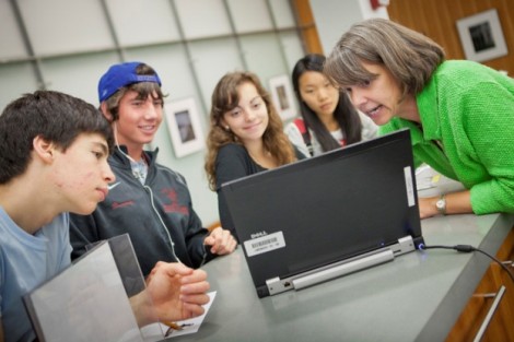 Terese  Heidenwolf, right, associate director of informational services, shows students some ways to access information at the library.