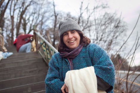 Local resident Michele Szoka attaches afghans to the steps.