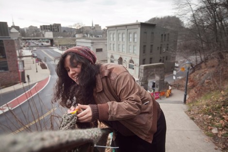Volunteer Kara Rosa attaches an afghan to the steps. 