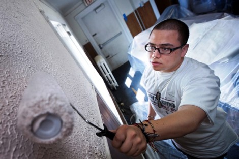 Edgar Gonzalez '14 paints inside the Easton Area Neighborhood Center.
