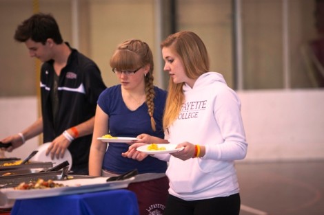 Haddie Maier '16, right, and her younger sister, Lily, check out the spread at the picnic.