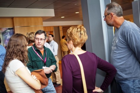 Art Kney, green shirt, associate professor and head of civil and environmental engineering, speaks with a family.