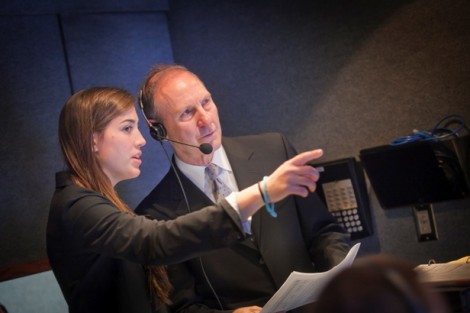 Producer Alison Dally ’13 works with Professor Mark Crain inside the production truck.
