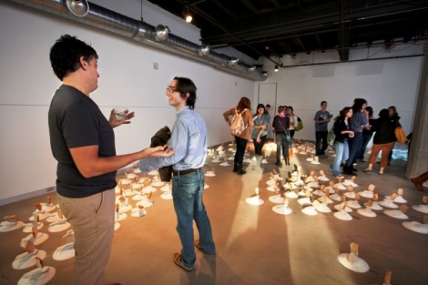 Nestor Armando Gil, left, assistant professor of art, speaks with his assistant, Mark Tajzler ’14. 