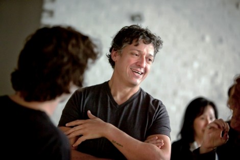 Nestor Armando Gil, assistant professor of art, speaks with guests.