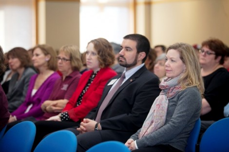 Staff and administrators listen to Alison Byerly. 
