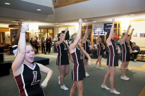 The cheerleaders welcome the president elect.