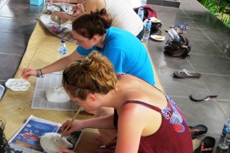 Students paint traditional Balinese masks.