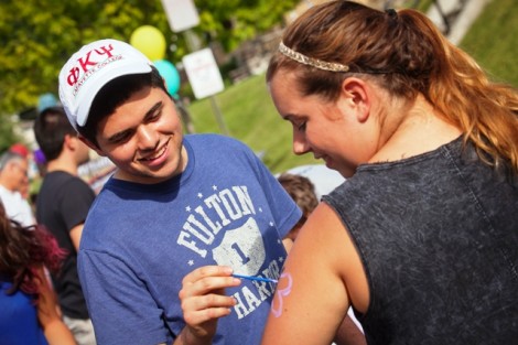 Brian Cantor ’15 paints a flower on another student.