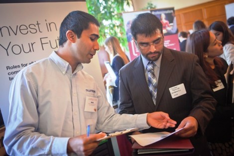 Sriram Gopalakrishnan '10 of Lutron looks over the resume of mathematics major Christian Ramirez ’14. 