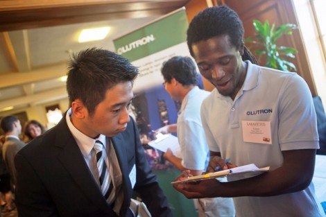 Franco Abott ’11 of Lutron looks over student resumes. 