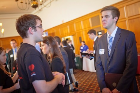 Ryan King ’12, left,  of Johnson and Johnson goes over some details with Matt Mabor ’16, an economics and government & law major. 