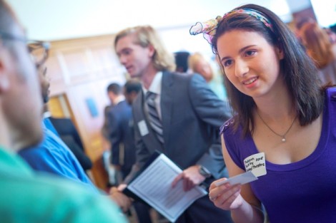 Biology and theater double major Trudyann Buckley ’15 hands out a business card.