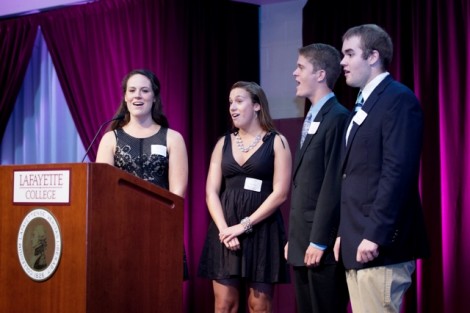 Students Allie Shumeyko '14, Maddie Zufschnitt '17, Mac Jones '16, and Adam Kline-Schoder '17 lead the dinner attendees in singing the 'Alma Mater.'