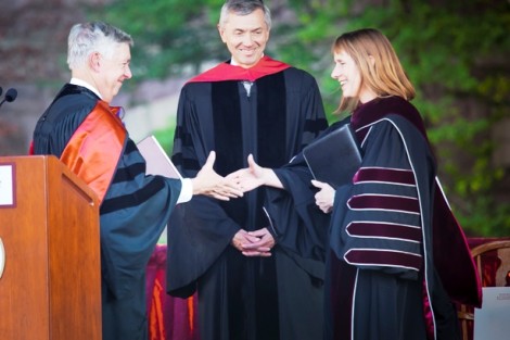 Edward Ahart ’69, left, chair of the Board of Trustees, and Stephen Pryor ’71, vice chair of the board, congratulate President Alison Byerly.