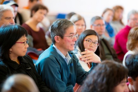 Kent Sheng poses a question to President Alison Bylery after her speech. Looking on are his wife Lauren and daughter, Julia '17.
