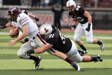 Defensive end Jake McTighe ’14 makes a tackle.
