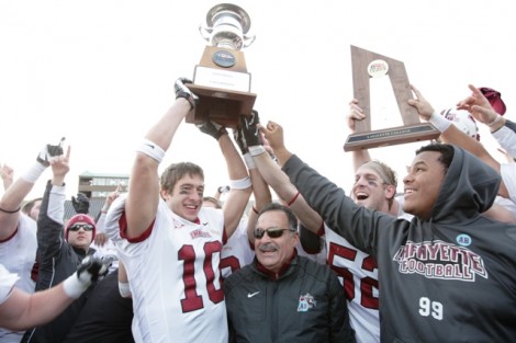 Receiver Mark Ross ’14 hoists the Patriot League Championship trophy.