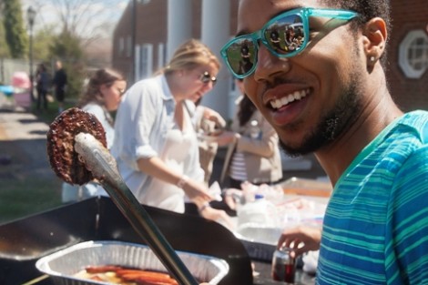 Bakari Boone ’15 grills hamburgers and hot dogs.