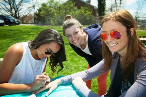 Ashley Bohnenberger ’15 paints henna tattoos on Kristie Mercadante ’15 and Emma Vigeland ’16.