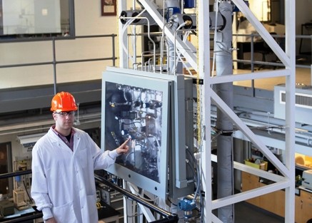 Seth Gottlund ’14 with the distillation plant