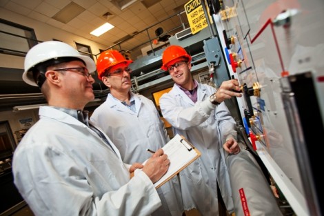 Professor James Ferri, David Taschler ’75, and Seth Gottlund ’14 work on the distillation plant.
