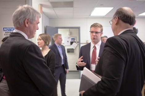 Symposium organizer Seth Gottlund ’14 speaks with guest about the distillation plant.