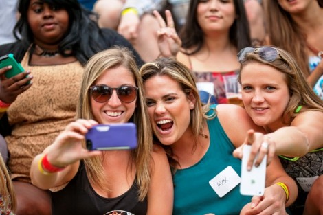 Students take a selfie before posing for the senior class photo.