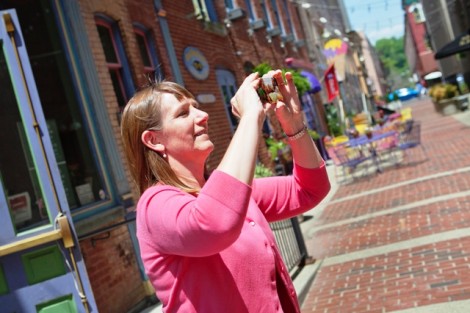 President Alison Byerly takes some photos of the karaoke competition to post on Twitter. 