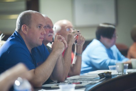 Christopher Thomas '98 and others listen to Prof. David Sunderlin discuss fossils.