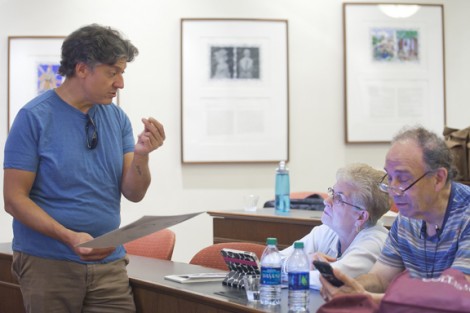 Prof. Nestor Armando Gil gives students guidance regarding their homework to create self-portraits using a pencil.