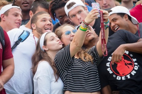 New students take a selfie before the class photo.