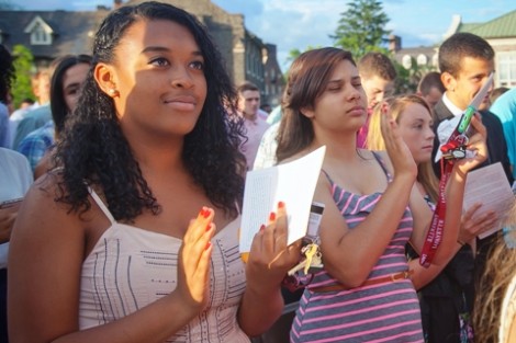 New students applaud as President Alison Byerly takes the podium.