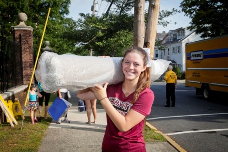 Cheerleaders help new students move in along McCartney Street.