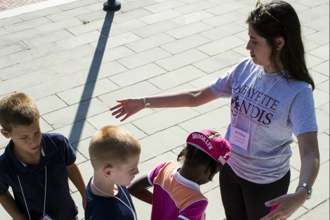 Ashley Ellis ’16 measures campers for their t-shirts.
