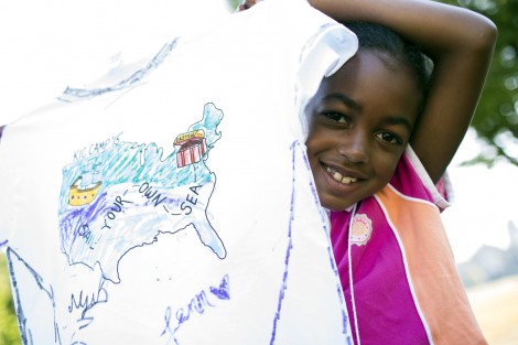 A happy camper shows off her artwork.