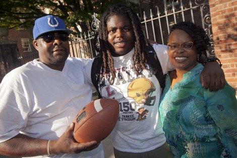 A first-year student takes a break from moving in to pose with his family.