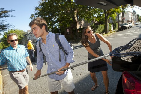A new family unloads the car on McCartney Street.