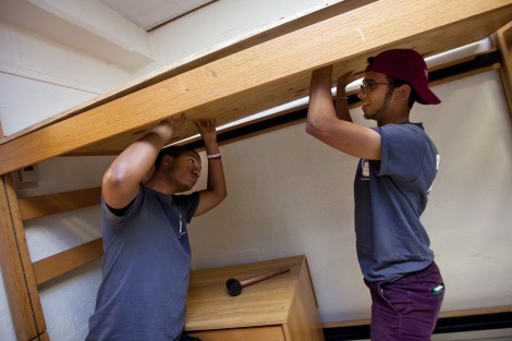 Resident assistants help raise a bed in McKeen Hall.